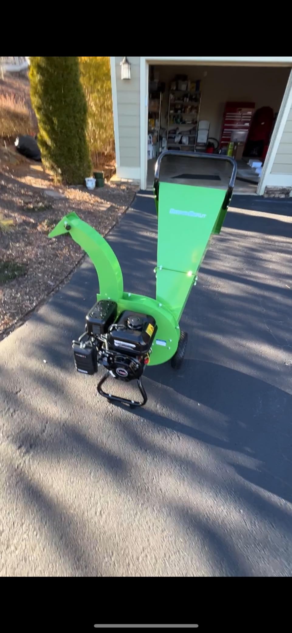 Newly assembled green GardenBeaut wood chipper on a driveway